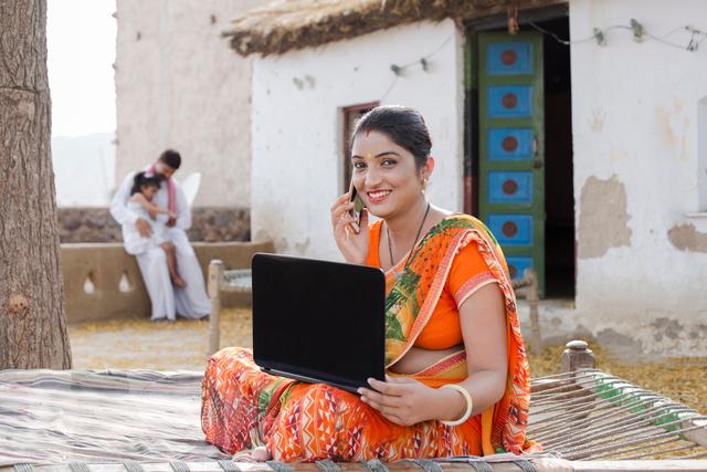 woman outside at home using wireless network to work